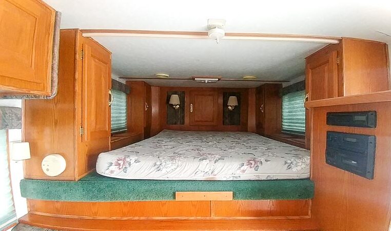 View of the Sleeping Area in a 1999 Sundowner Horse Trailer at Luxury Coach