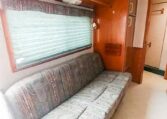 View of the Sofa in a 1999 Sundowner Horse Trailer at Luxury Coach