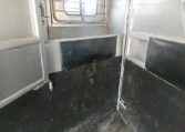 View of the Horse Stalls in a 1999 Sundowner Horse Trailer at Luxury Coach