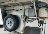 View of the LP Tanks and Spare Tire in a 1999 Sundowner Horse Trailer at Luxury Coach